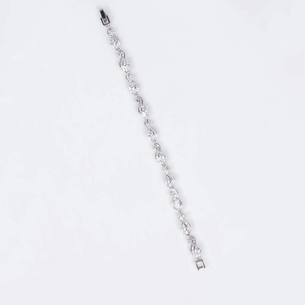 Women's copper geometric line bracelet with inlaid blue zircon stones on a white background