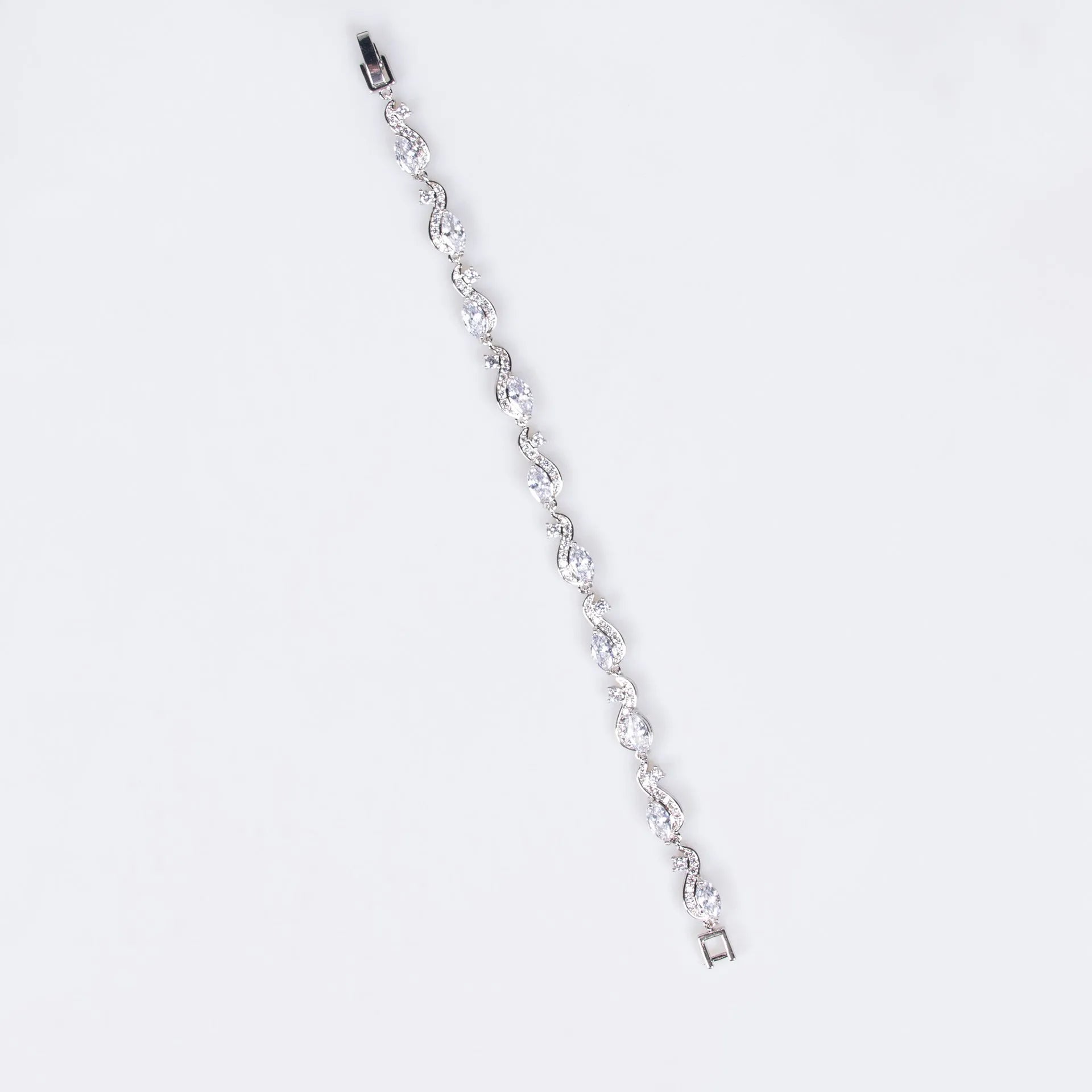 Women's copper geometric line bracelet with inlaid blue zircon stones on a white background