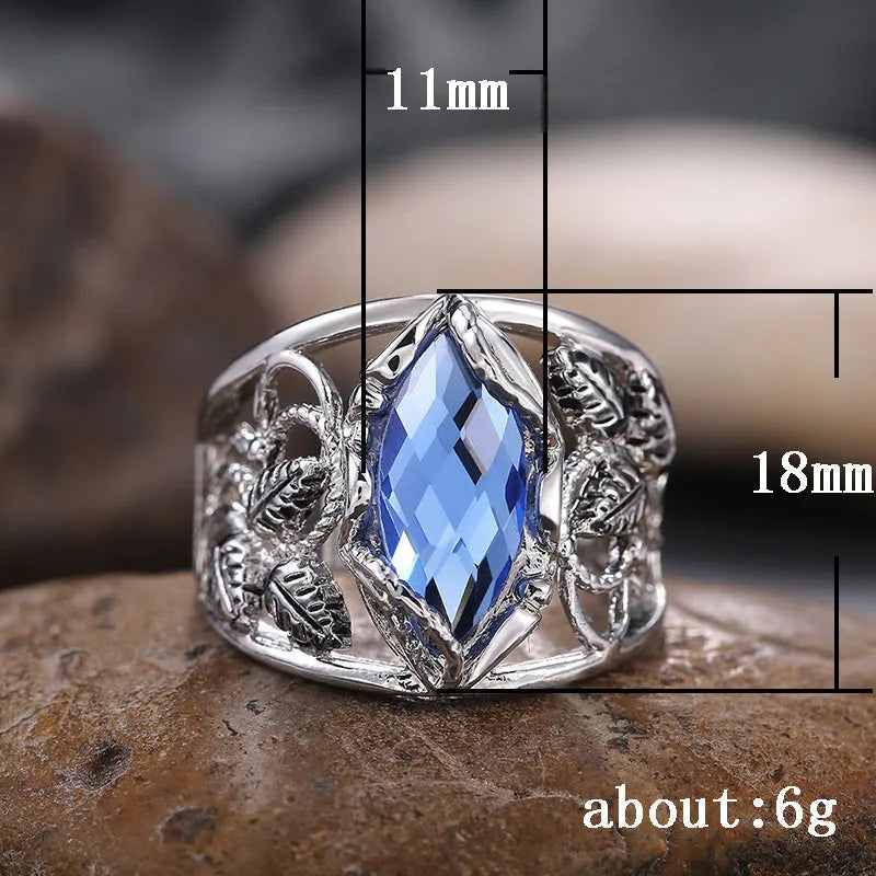Women's horse eye-shaped blue crystal alloy ring on a hand, showing geometric design.