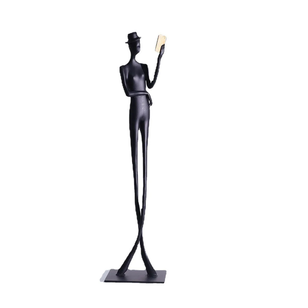 Black metal reading woman desktop sculpture made of cast aluminium measuring 51 cm tall