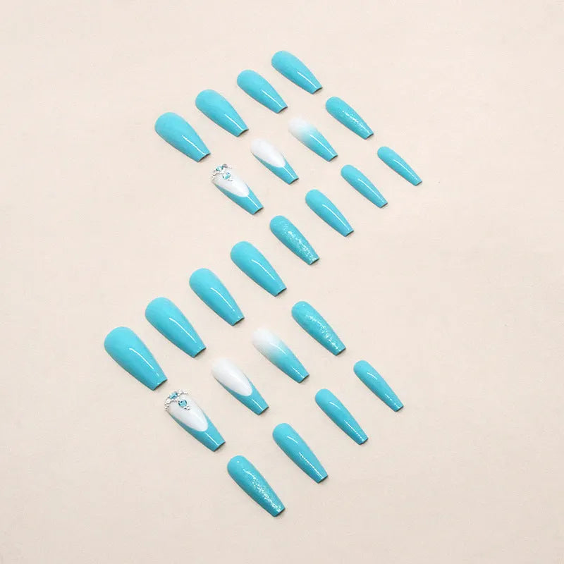 Long oval ballet false nail art patches with a solid smart blue diamond design and glue bottle.
