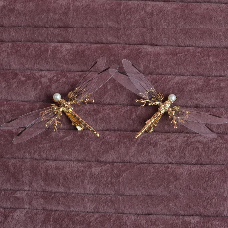 Golden dragonfly-shaped women's hair clip made from alloy with a side fastening.