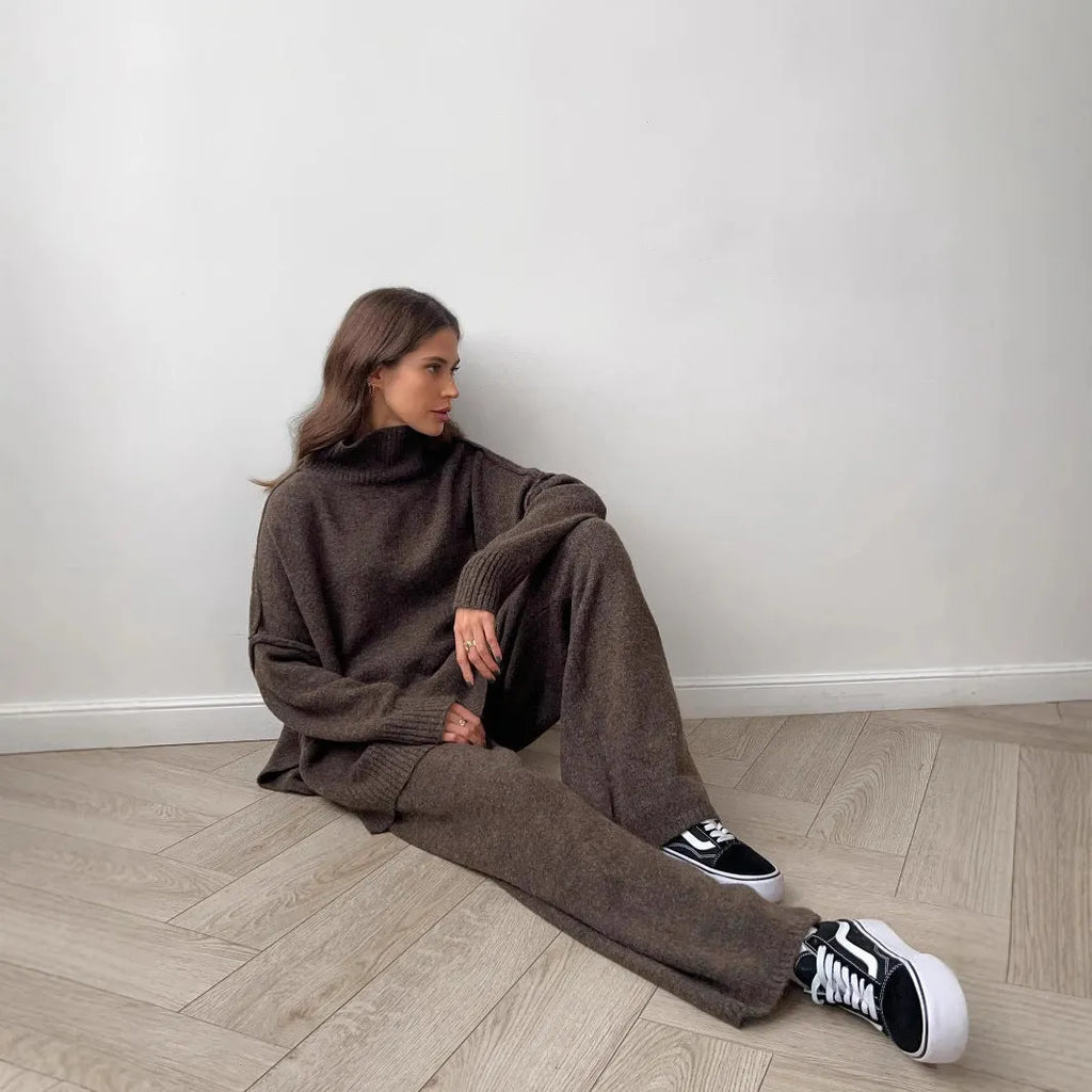 Women's acrylic knit sweater suit with side-slit top and matching trousers in dark grey