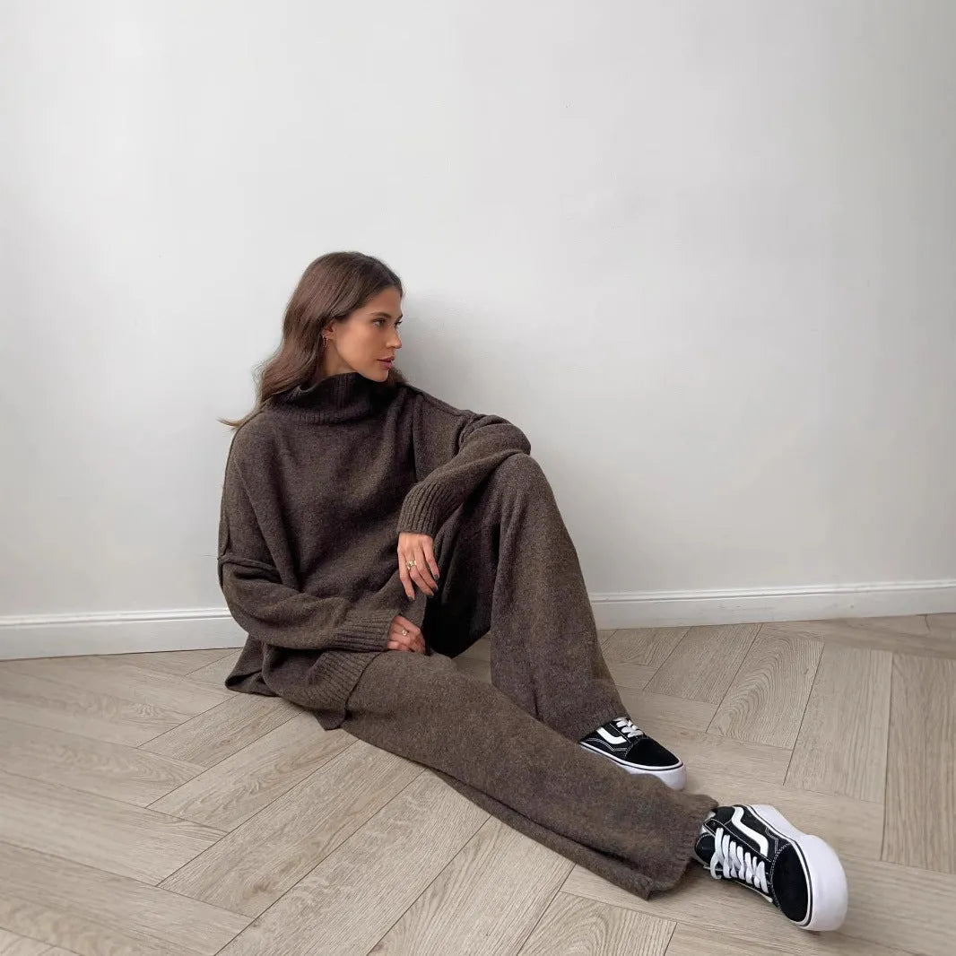 Women's acrylic knit sweater suit with side-slit top and matching trousers in dark grey