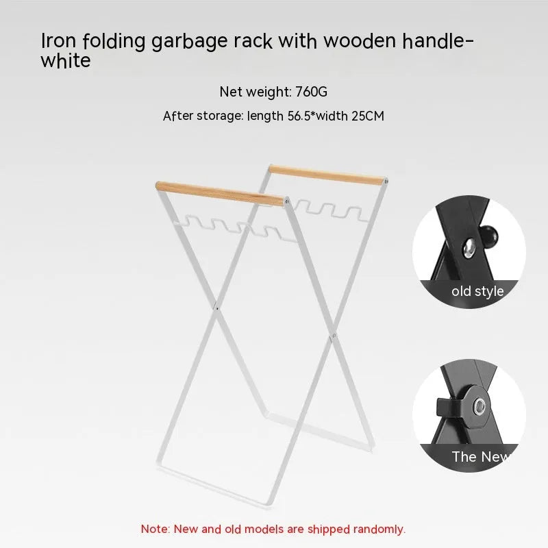 Black outdoor folding iron trash rack with wooden handle holding a rubbish bag.