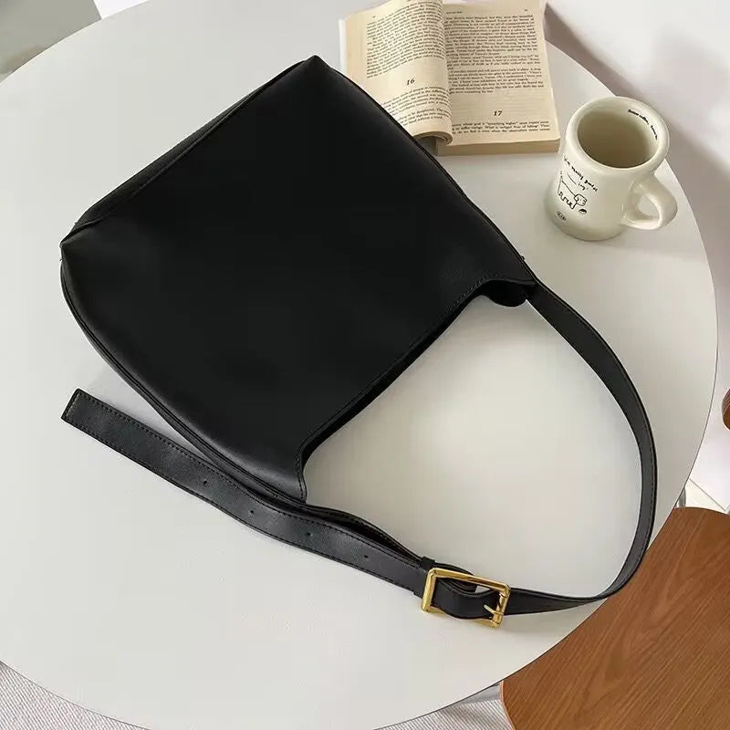 Women's soft PU shoulder bag with swing threads decoration in black and brown colour options