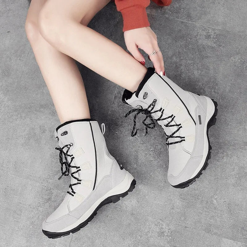 Women's black mid-calf leather snow boot with a textured non-slip rubber sole.