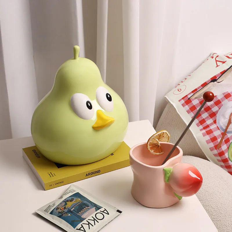 White porcelain pear-shaped ceramic tissue box in green colour on wooden desktop