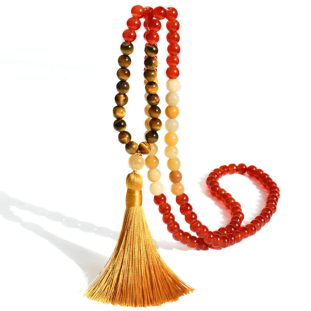Long 108-bead natural stone necklace with colour-matched tassels and a geometric gem-inlaid pendant on a ball bead chain.