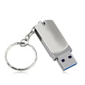 Small white metal rotating USB flash drive on a plain background