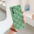 Black silicone diamond texture phone case for Huawei P40 Pro on a table.