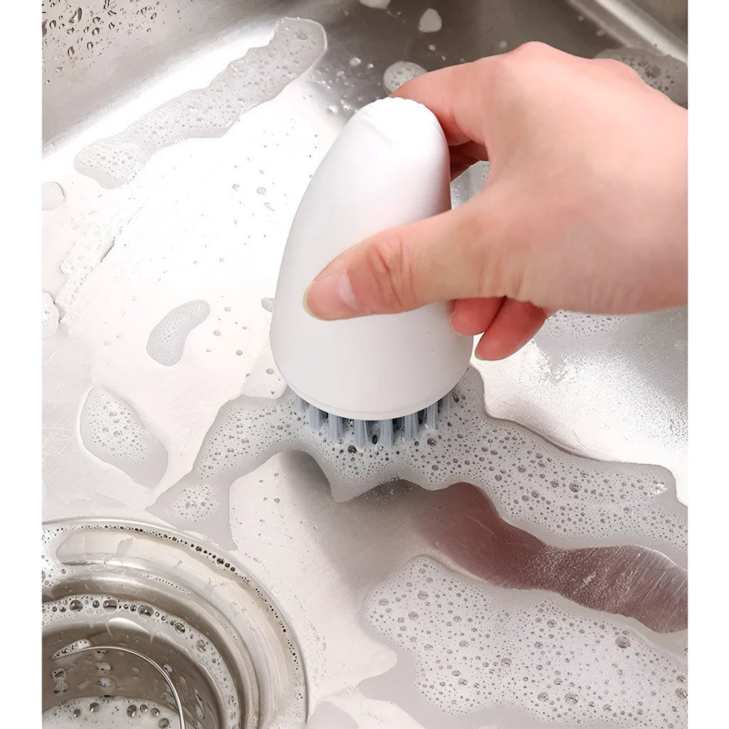 Carrot-shaped orange kitchen brush with nylon bristles for cleaning vegetables
