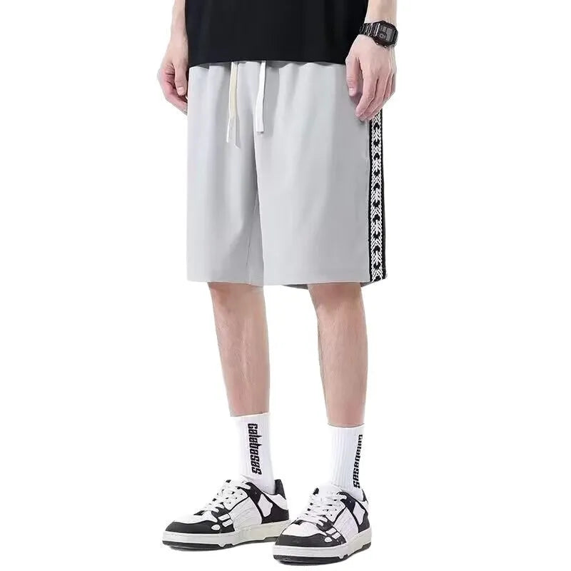 Men's black baggy track pants with loose fit and elasticated waistband for casual sports wear