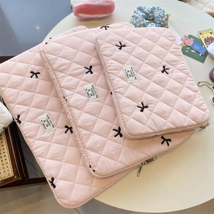 Cute rhombus embroidered bow laptop storage bag in nylon, shown in light pink colour.