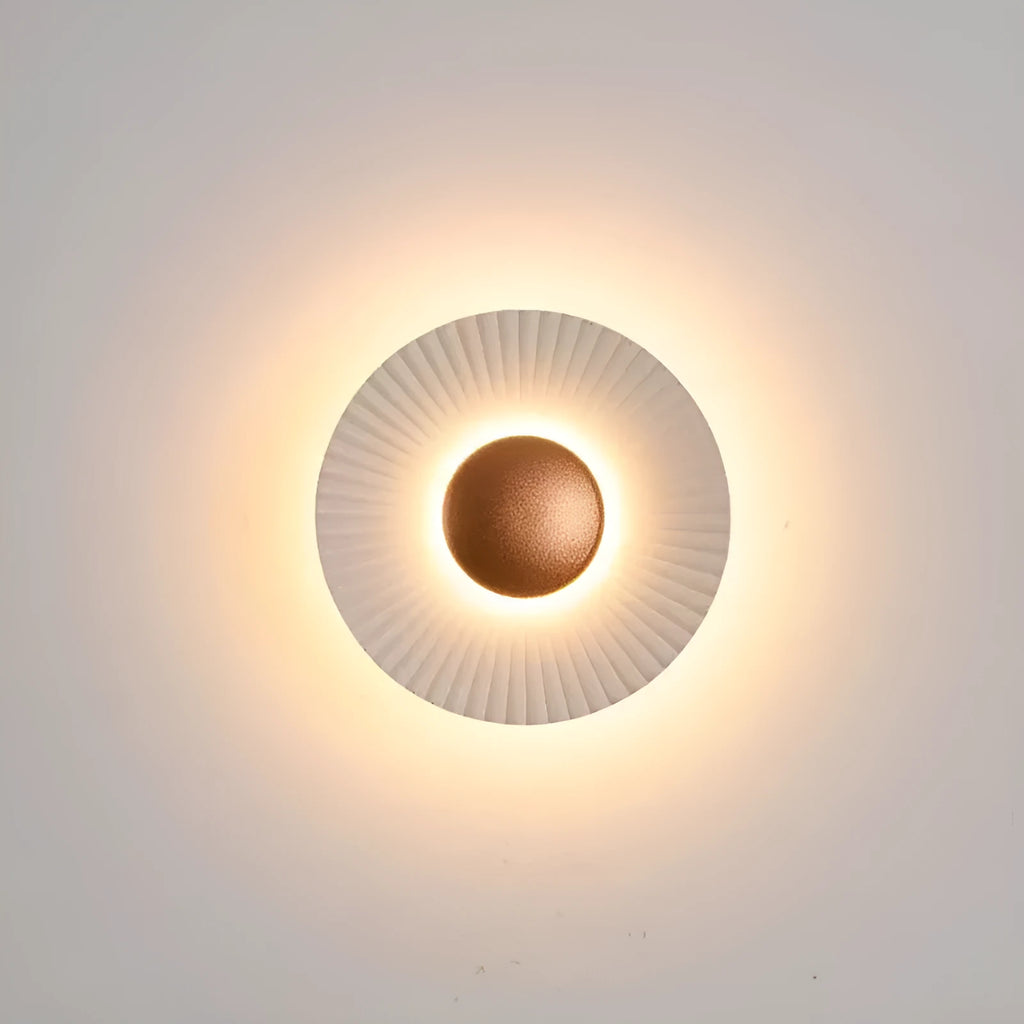 Round aluminium wall lamp mounted on a wall, showing LED illumination.