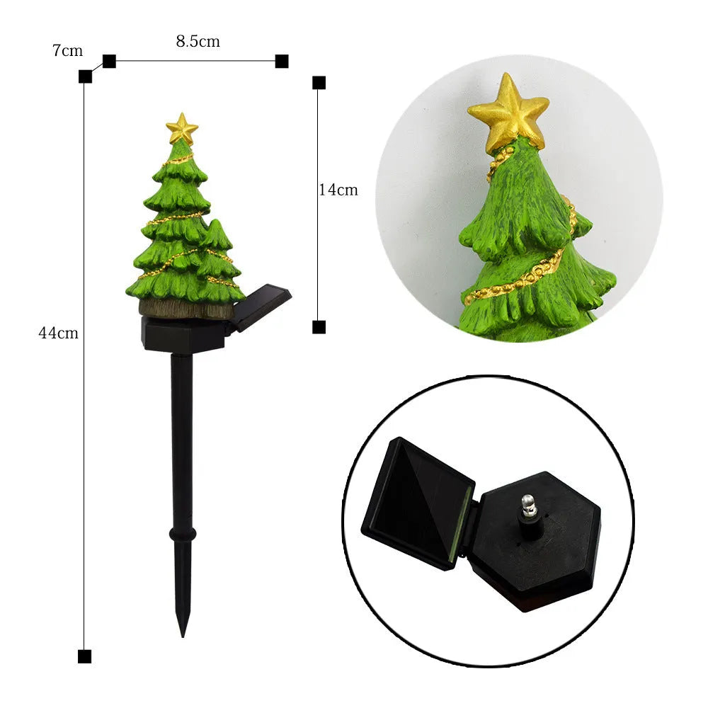 Solar Christmas tree ground plug light with warm white LED, resin body and 40 x 40mm solar panel for outdoor garden use.