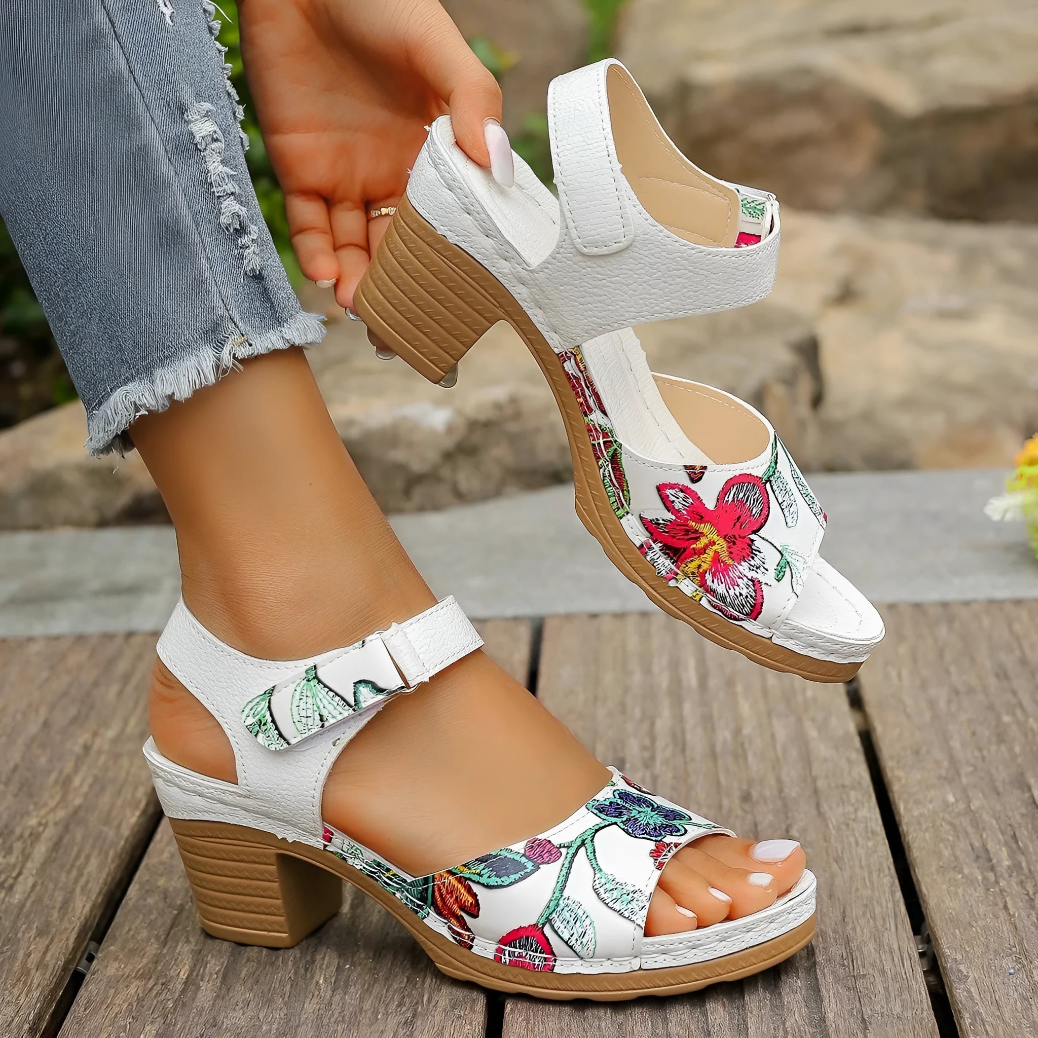 White women's high heel sandals with an adjustable velcro strap buckle fastening.