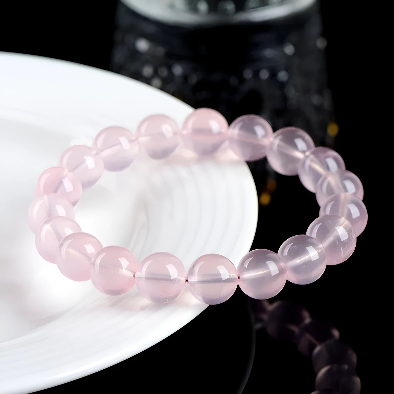 Women's crystal bracelet with round polished beads in pink, showing size options from 6mm to 22mm diameter
