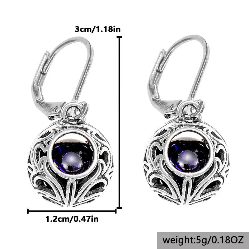 Women's geometric earrings with vintage engraving and hollow blue gemstone pendants in silver colour