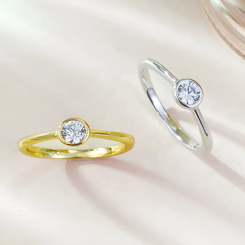 Minimalist crown-shaped silver ring with linear design in electroplated gold or platinum finish.