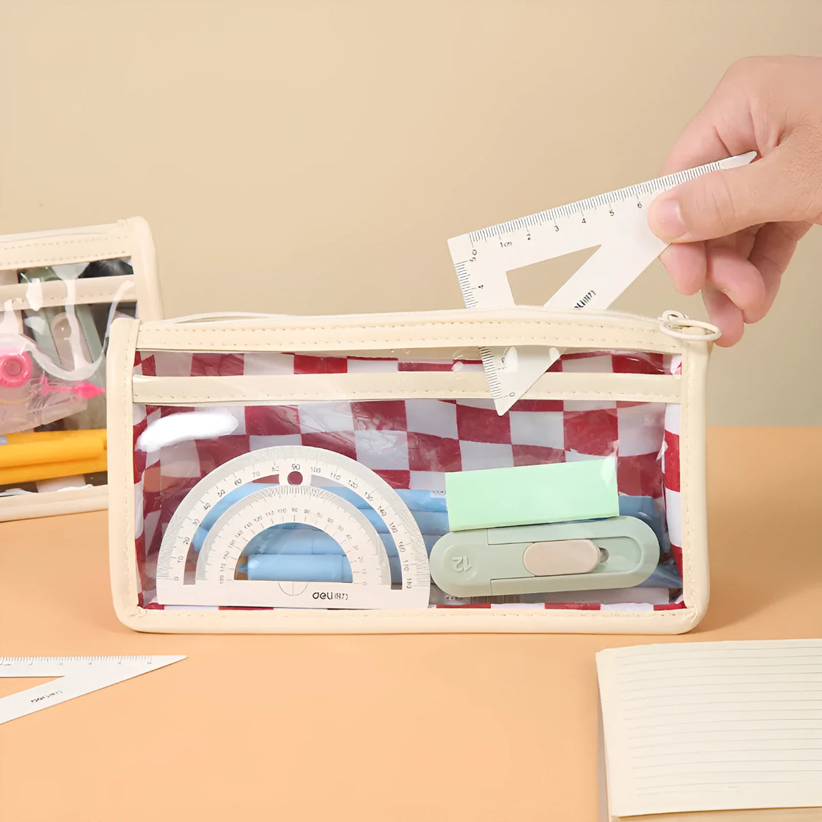 Transparent PVC pencil case with chessboard grid pattern showing pens inside, dimensions 21.5cm x 8cm x 11.5cm