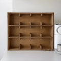 Square solid birch wood cup storage rack with multiple grid compartments in a natural meridian colour.