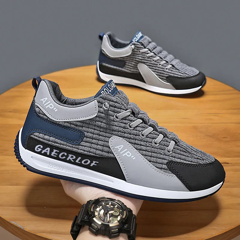 Men's grey and green low-top mesh running shoes with lace-up front.