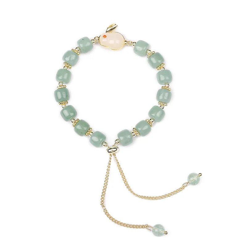 Rabbit charm bracelet with green aventurine and strawberry quartz stones on a gold plated copper chain