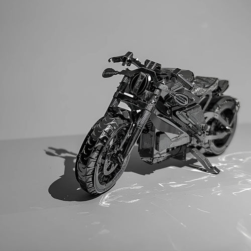 DIY 3D metal puzzle kit showing the Electric Toy Motorcycle model assembled on a table