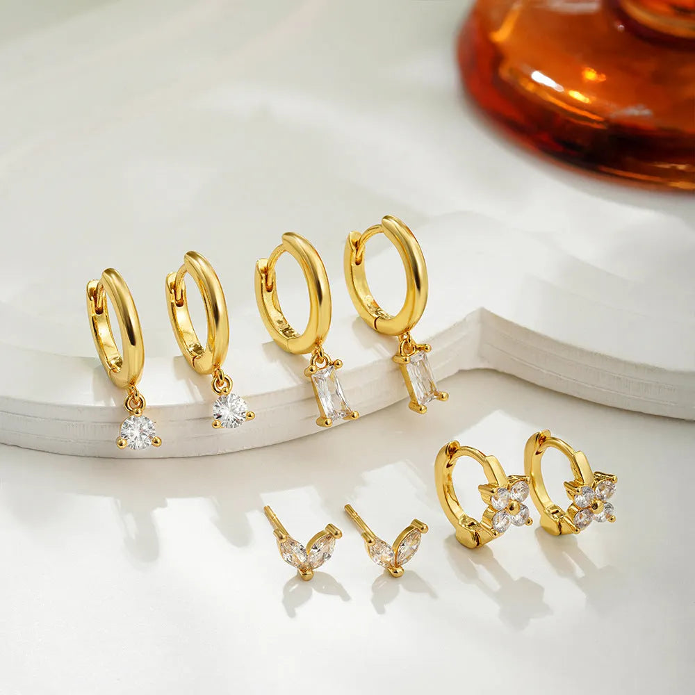 Geometric square copper earrings with zircon plating in gold or silver colour, showing star, quadrilateral, ellipse and ring shapes