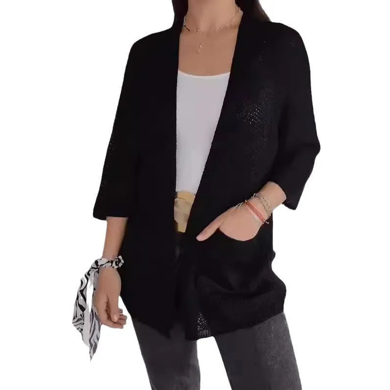 Women's army green waffle texture cardigan coat with nine-quarter sleeves and pockets on a hanger.