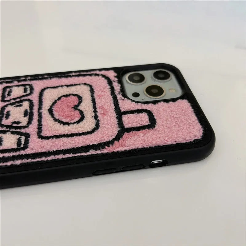 Pink towel embroidered soft TPU case for iPhone on a table.