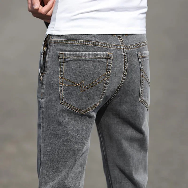 Man wearing smoky gray low-waist straight-leg jeans made from high-elasticity rabbit fur fabric.
