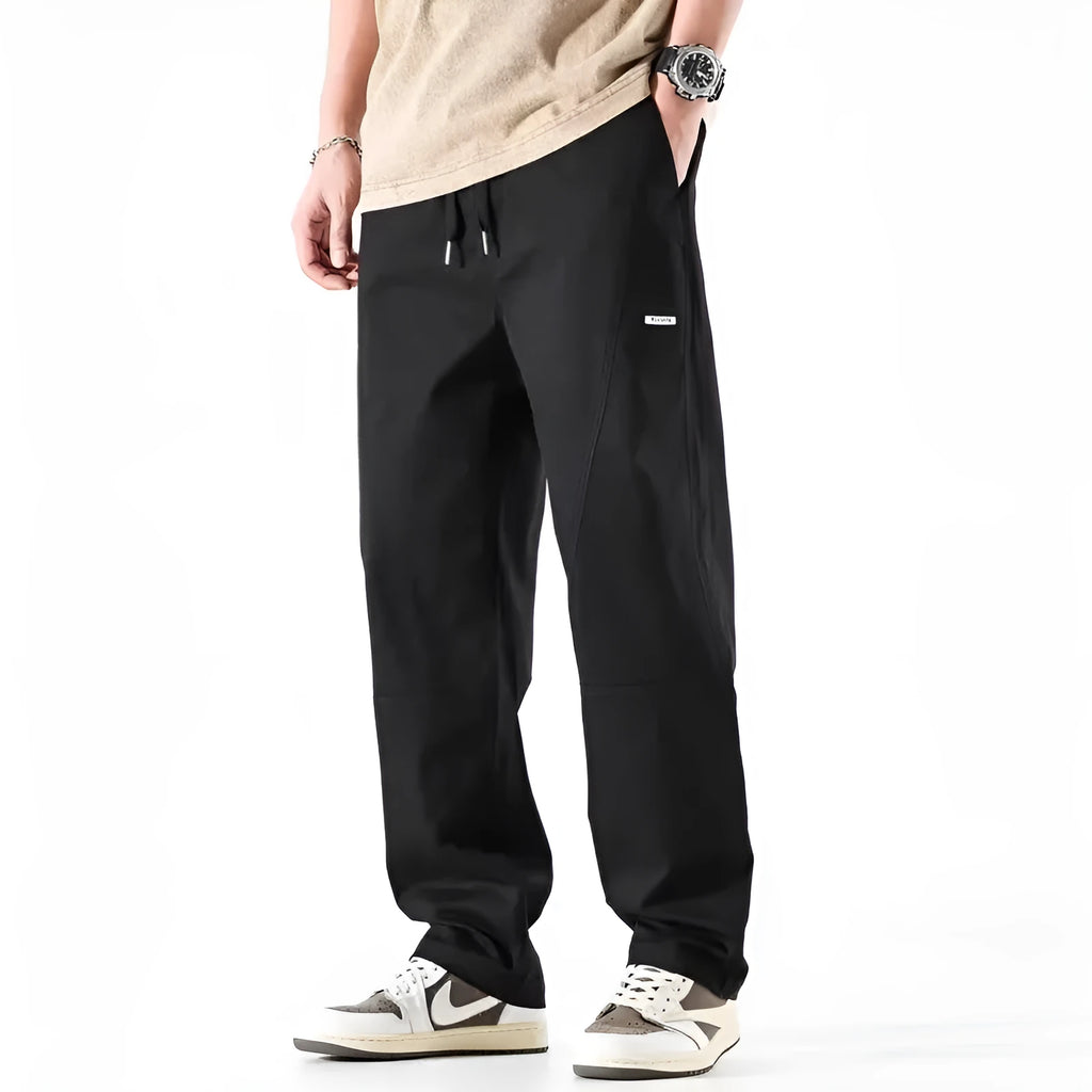 Milky white cotton wide-leg casual trousers with an elasticated waistband laid flat.