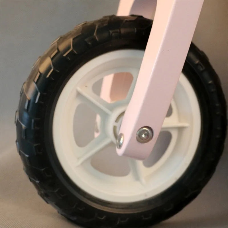 Pink wooden balance scooter for toddlers aged 1 to 6 years, 10 inches long.