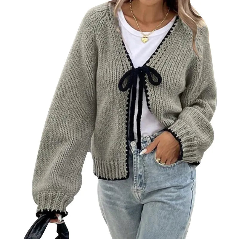 Women's grey lace-up cardigan with crocheted flowers on the front and loose long sleeves.