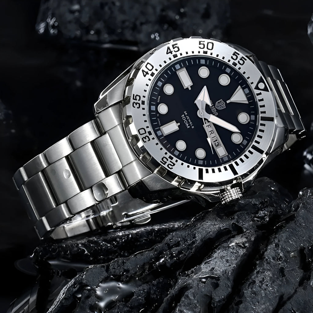Men's silver waterproof quartz watch with luminous blue dial and steel bracelet on wrist