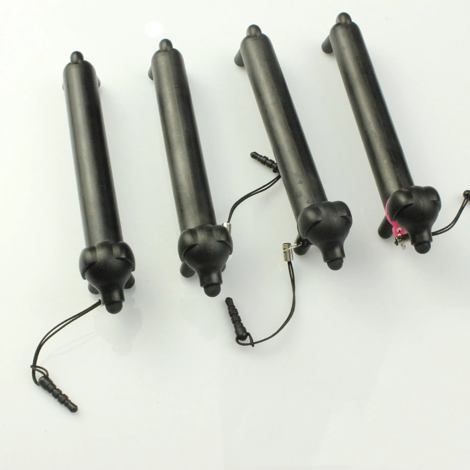 Black puppy-shaped touch screen stylus pen shown in dual-length positions with phone holder function