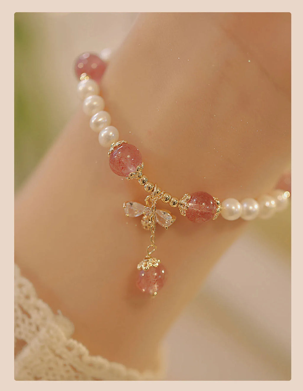 Women's strawberry quartz crystal bracelet with bow detail on wrist
