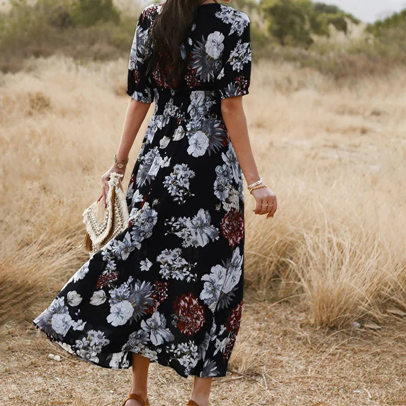 Yellow floral print summer dress with V-neck, short sleeves, and an elastic high waist on a mannequin.