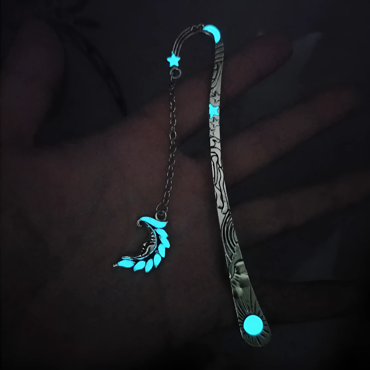 Retro five-pointed star glowing metal bookmark in ancient silver or bronze with sun, moon and stars design