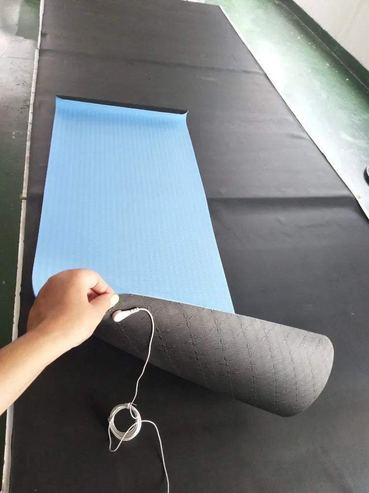 Blue conductive grounding yoga mat with plants pattern and integrated wire, 182cm long.