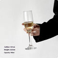 Clear glass French champagne goblet on a table.