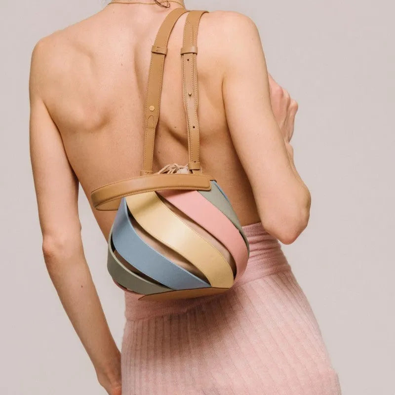 Cylindrical diamond quilted bucket bag in beige with contrast stitching