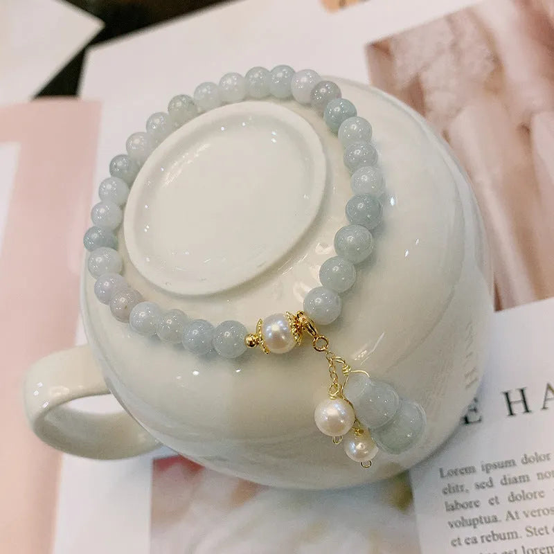 Emerald jade bracelet with hand-carved gourd design in traditional Chinese style