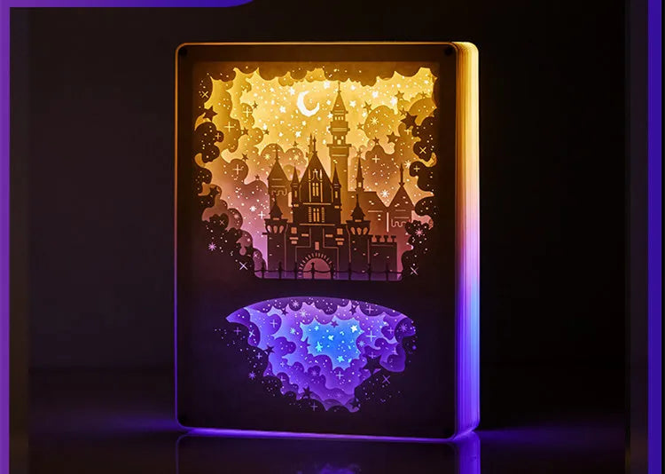 Bedside night light with 3D paper carving design, USB cable, and remote control on wooden surface