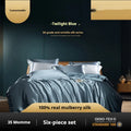 Silk four-piece quilt cover set in solid colour displayed on bed with pillowcases