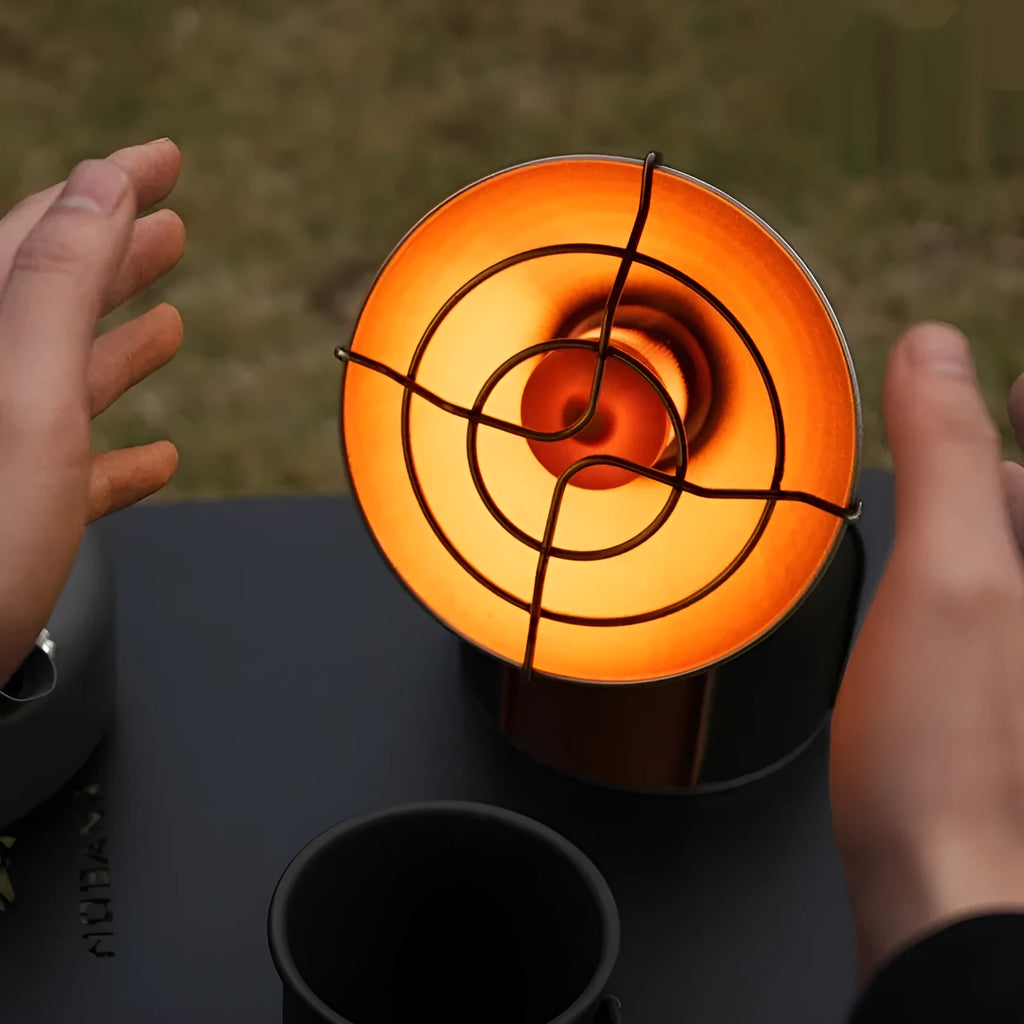 Black and orange portable outdoor heating stove with automatic ignition for camping