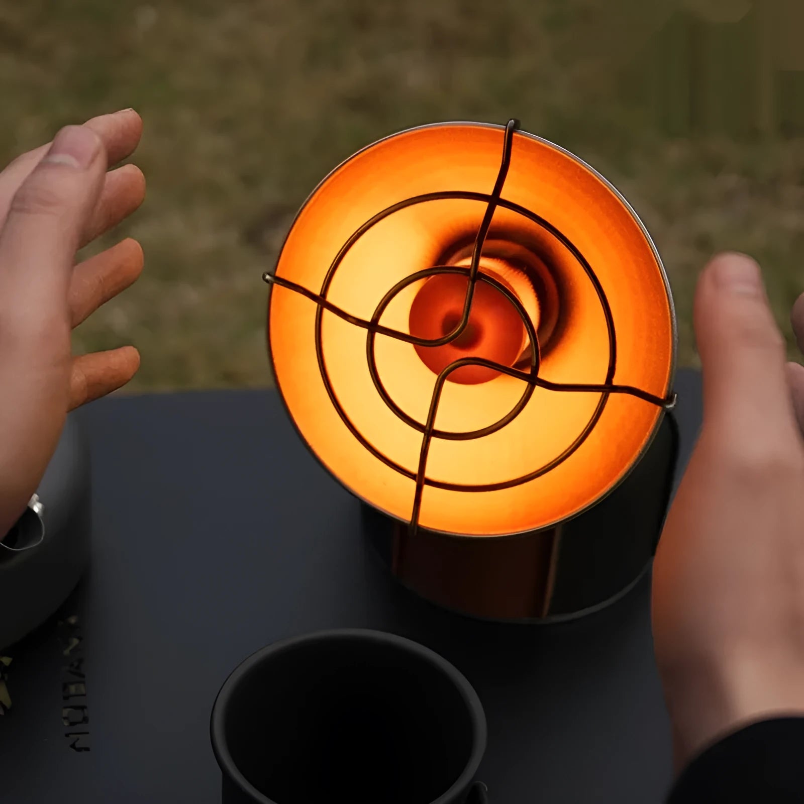 Black and orange portable outdoor heating stove with automatic ignition for camping