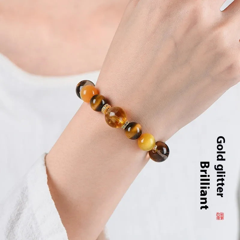 Yellow artificial crystal bracelet with 10mm Jinba large beads on a string.
